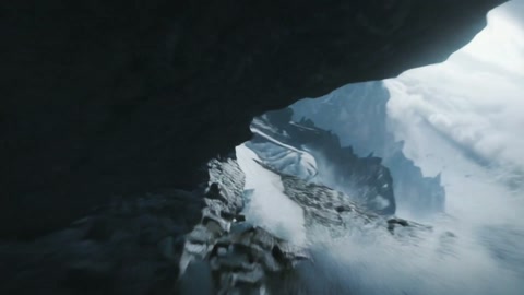 Camera plunges along a craggy alpine ridge